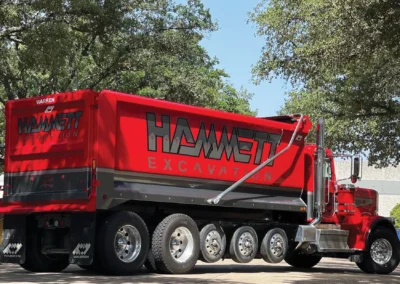 High-impact custom vehicle wrap for Hammett Excavation designed for heavy hauling durability.