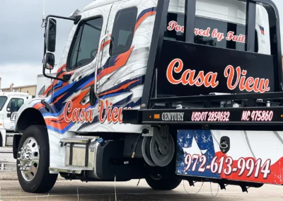 Close-up of Casa View branded graphics on a flatbed tow truck wrap with clean vinyl application and vibrant printed details.