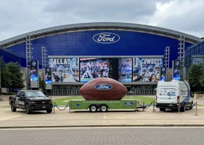 Large-scale football-themed graphics installed throughout Ford Center at The Star featuring bold branding elements and custom environmental signage.